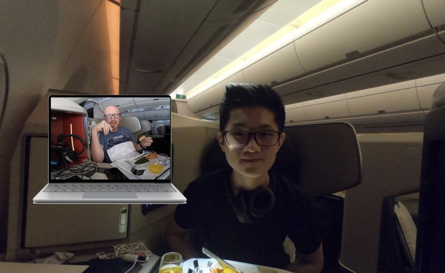 a man sitting in a chair with a laptop and a plate of food