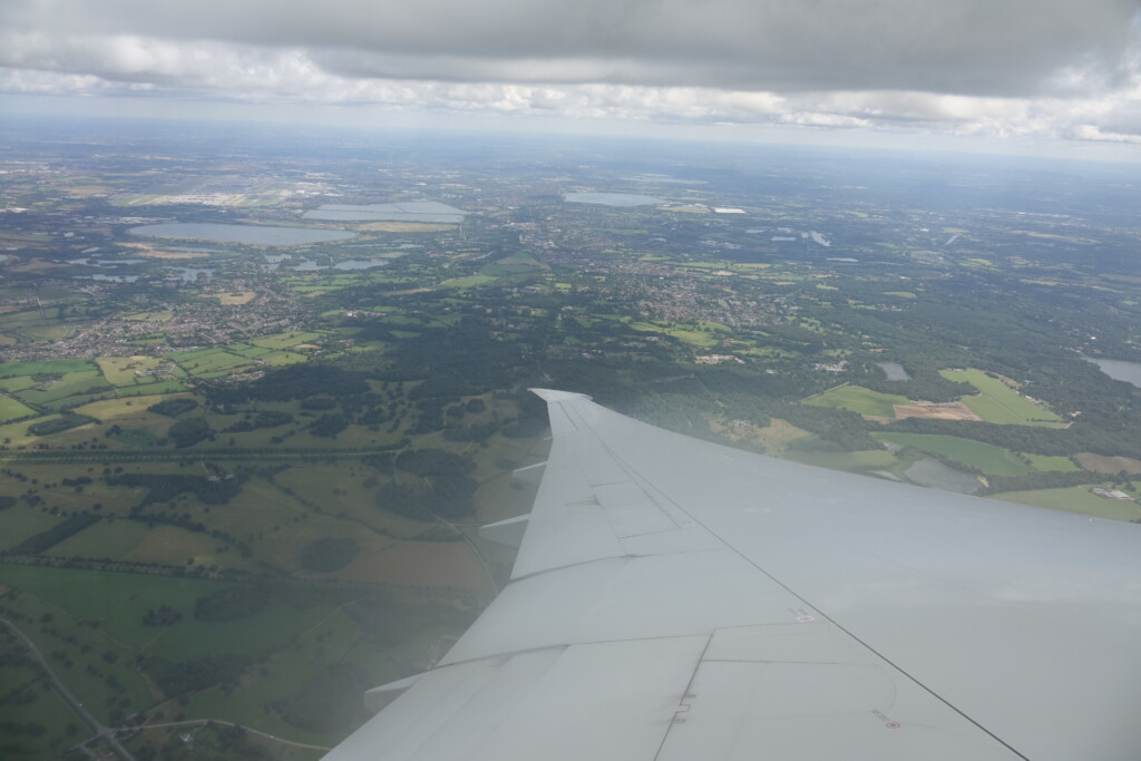 an airplane wing and a landscape