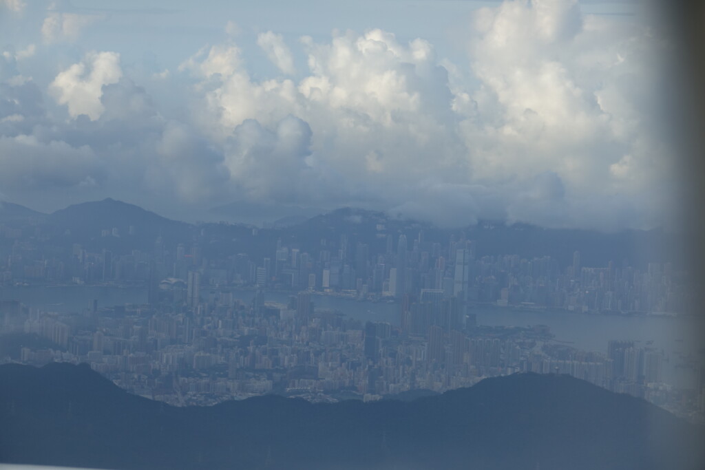 a cityscape with mountains and clouds