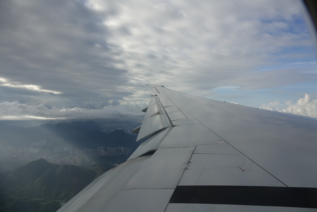 the wing of an airplane above a city