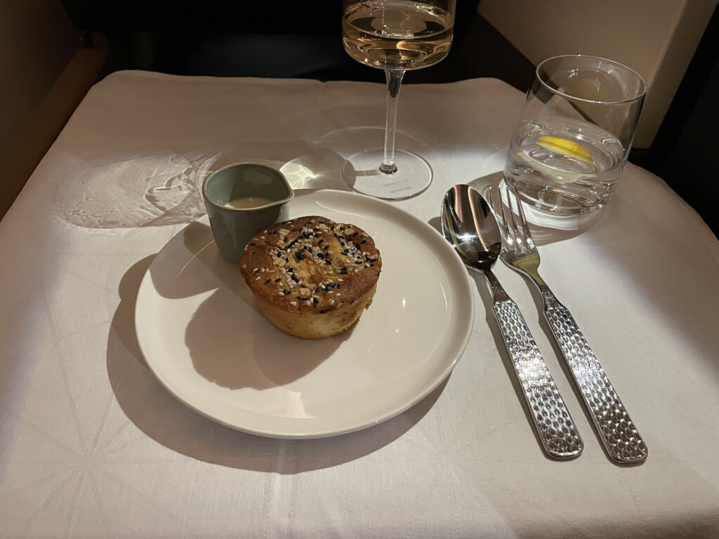 a plate with food on it and a glass of water and spoon