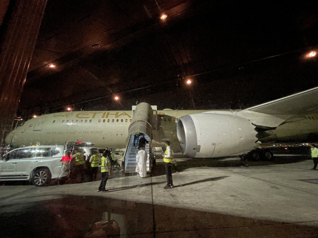 people standing next to an airplane