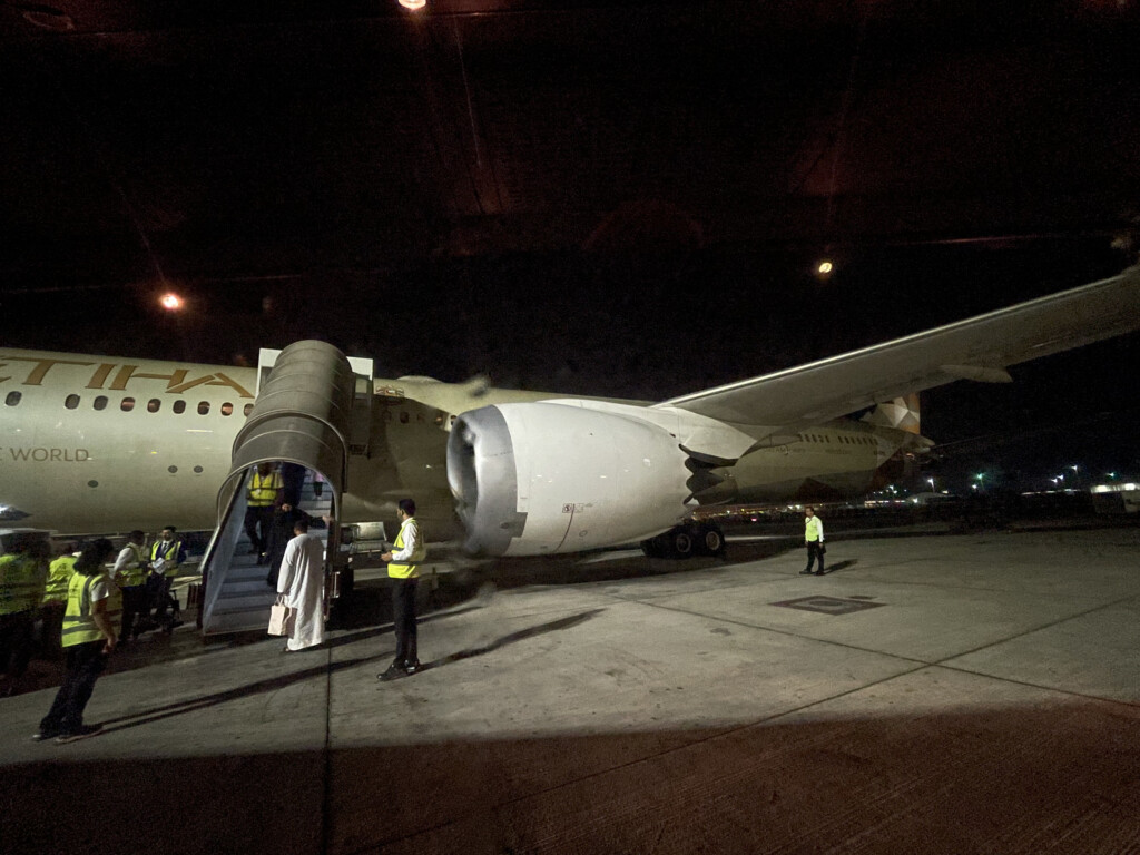 people standing next to an airplane