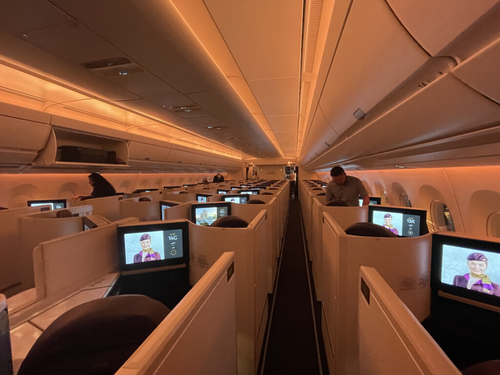 a group of people sitting in rows of seats with computers