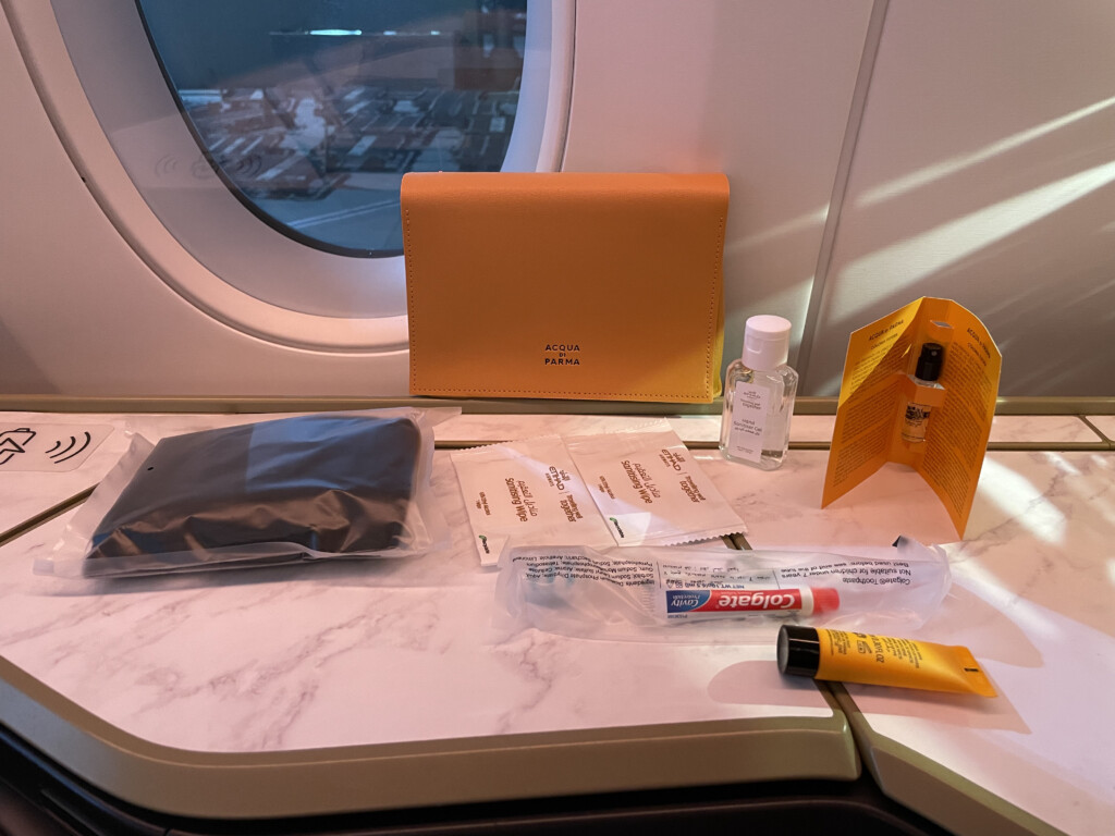 a table with a wallet and a small bottle of liquid on it