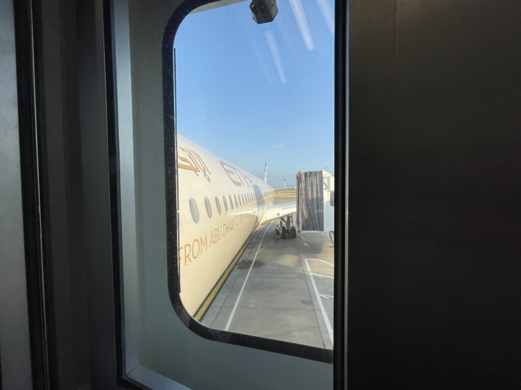 a window with a plane on the ground