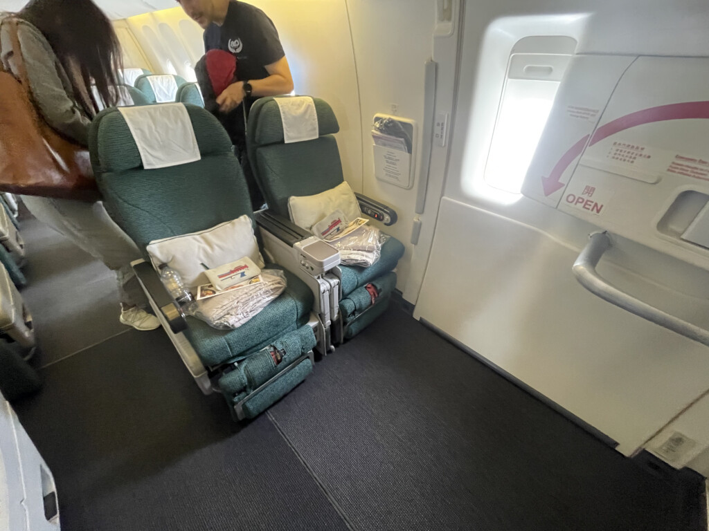 a man standing next to a group of seats on an airplane