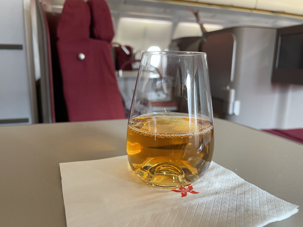 a glass of liquid on a napkin on a table