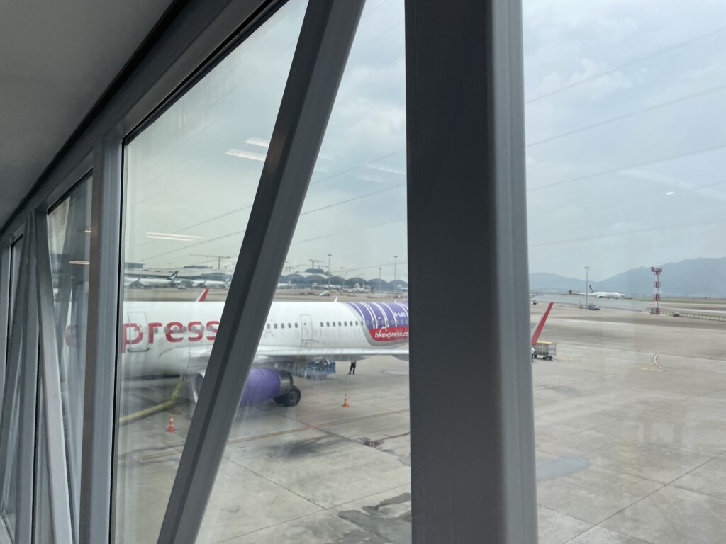 a window with a plane on the tarmac