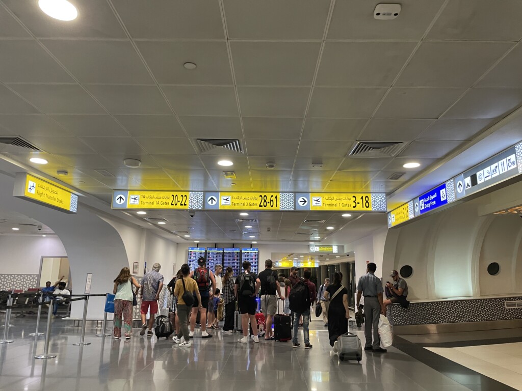 a group of people standing in a room with luggage