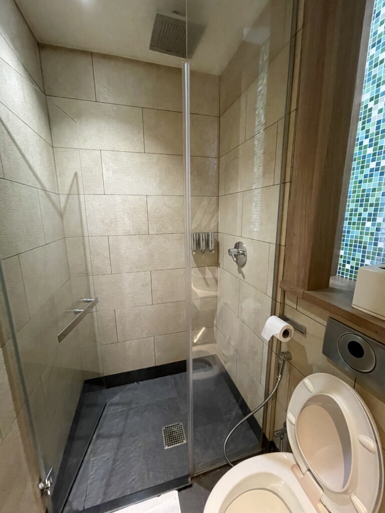 a bathroom with a glass shower and toilet