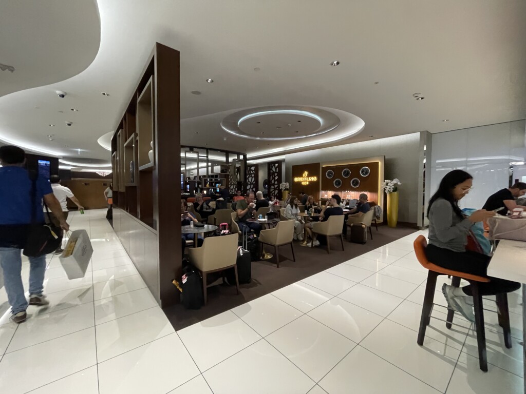 a group of people sitting at tables in a restaurant