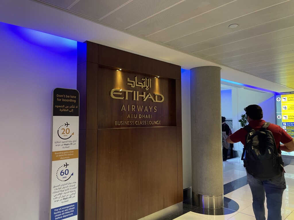 a man standing in front of a sign