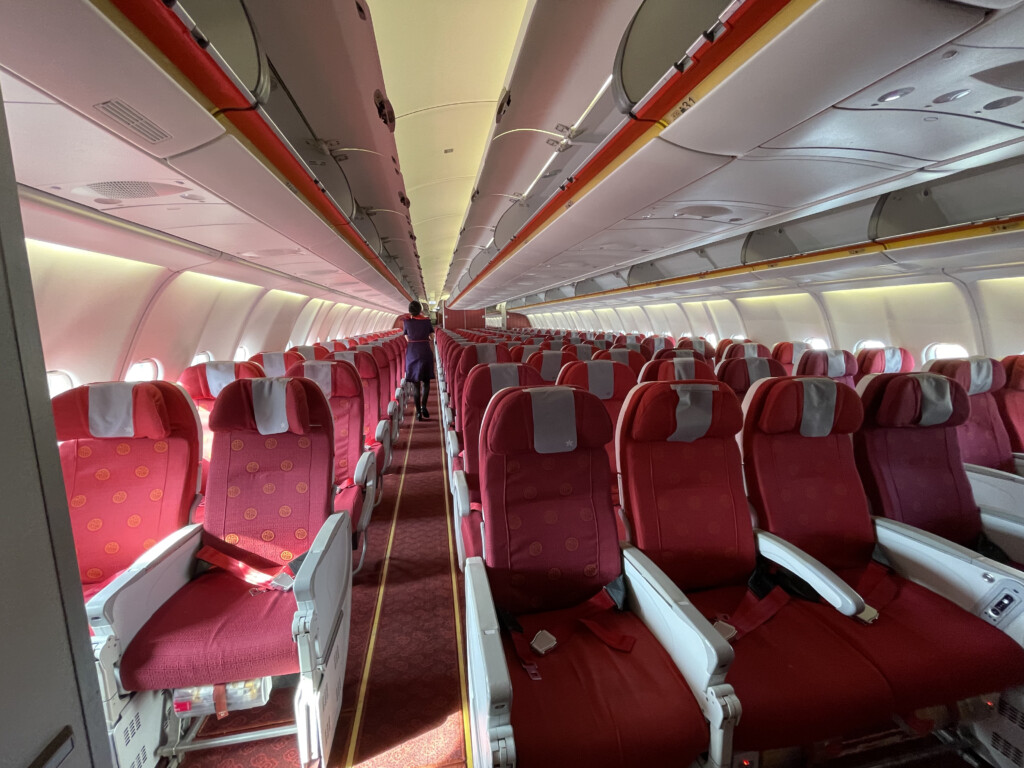 a person standing in a row of red seats