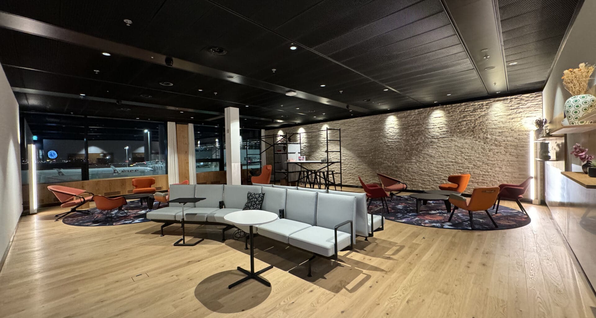 a room with a large group of chairs and a wall