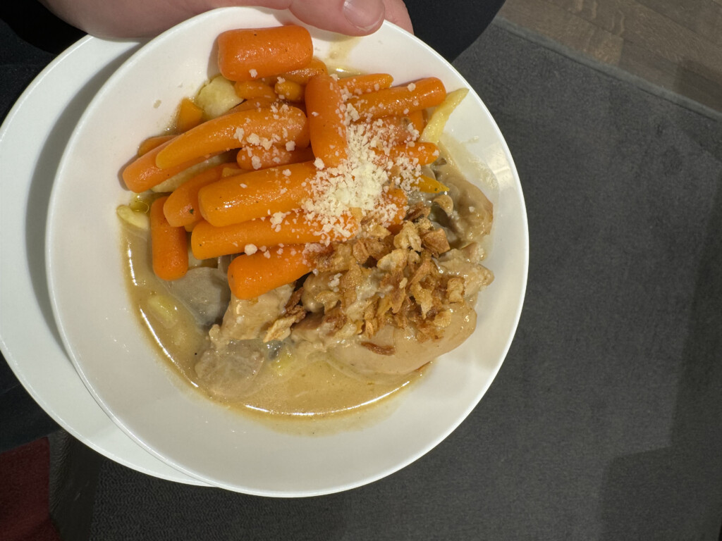 a bowl of food with a person holding it