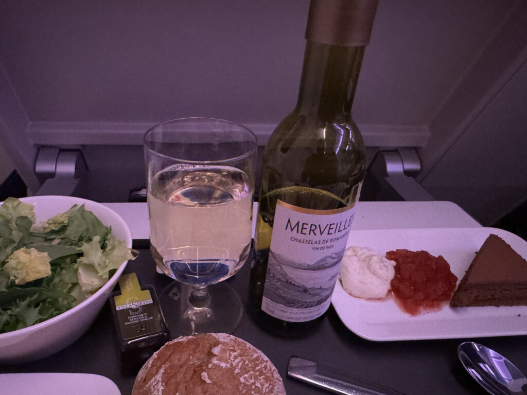 a wine bottle and a bowl of food on a table