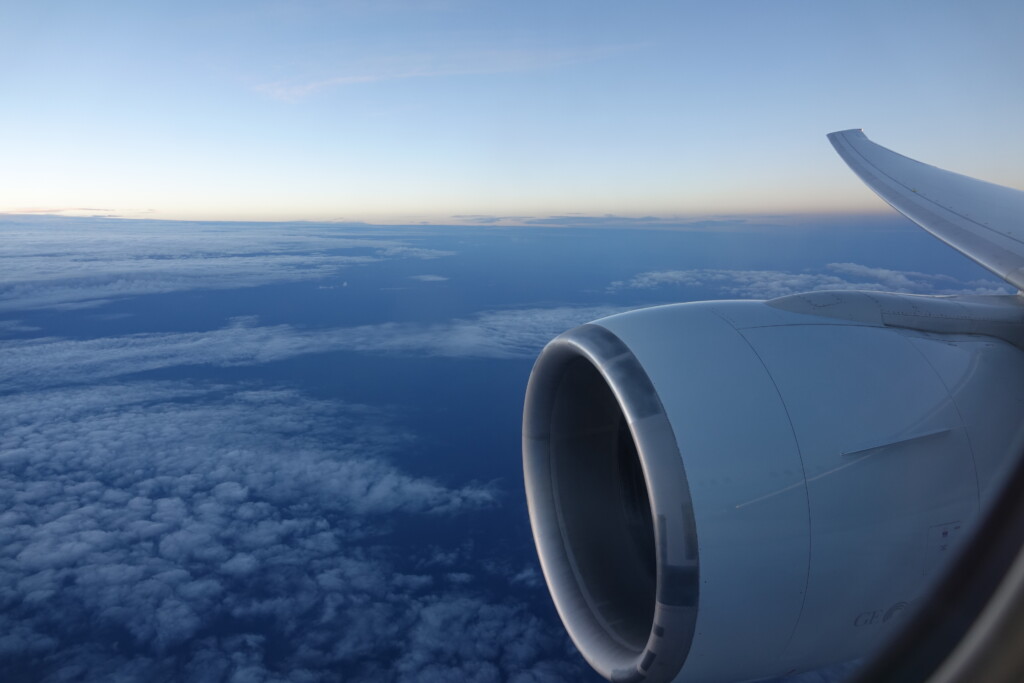 an airplane wing and a blue sky