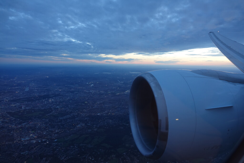 an airplane wing and a city below