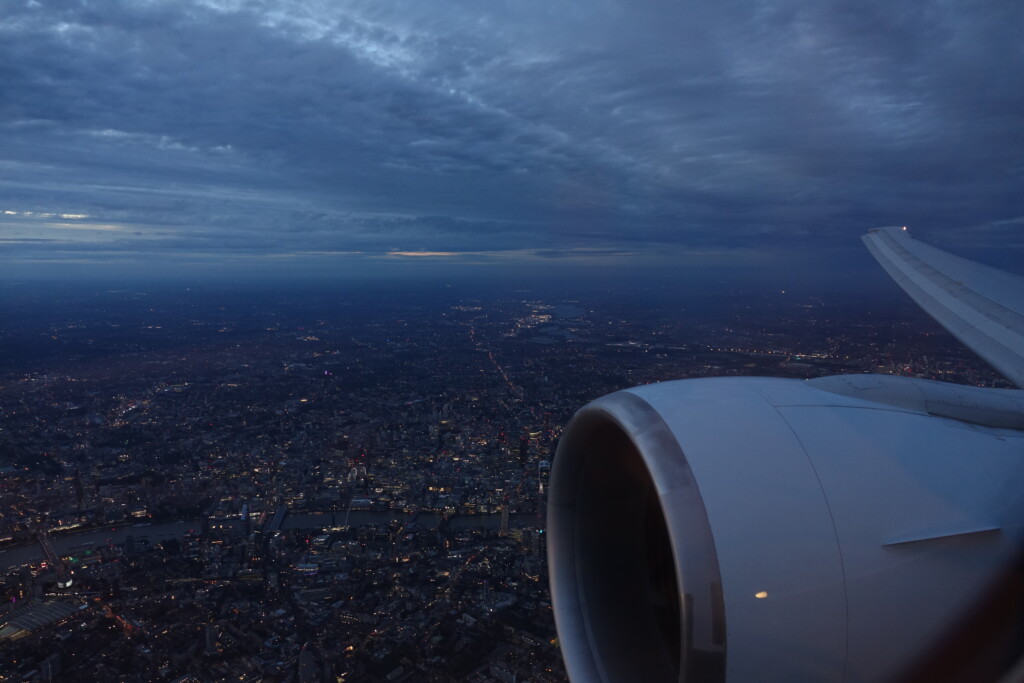 an airplane wing and engine of a city