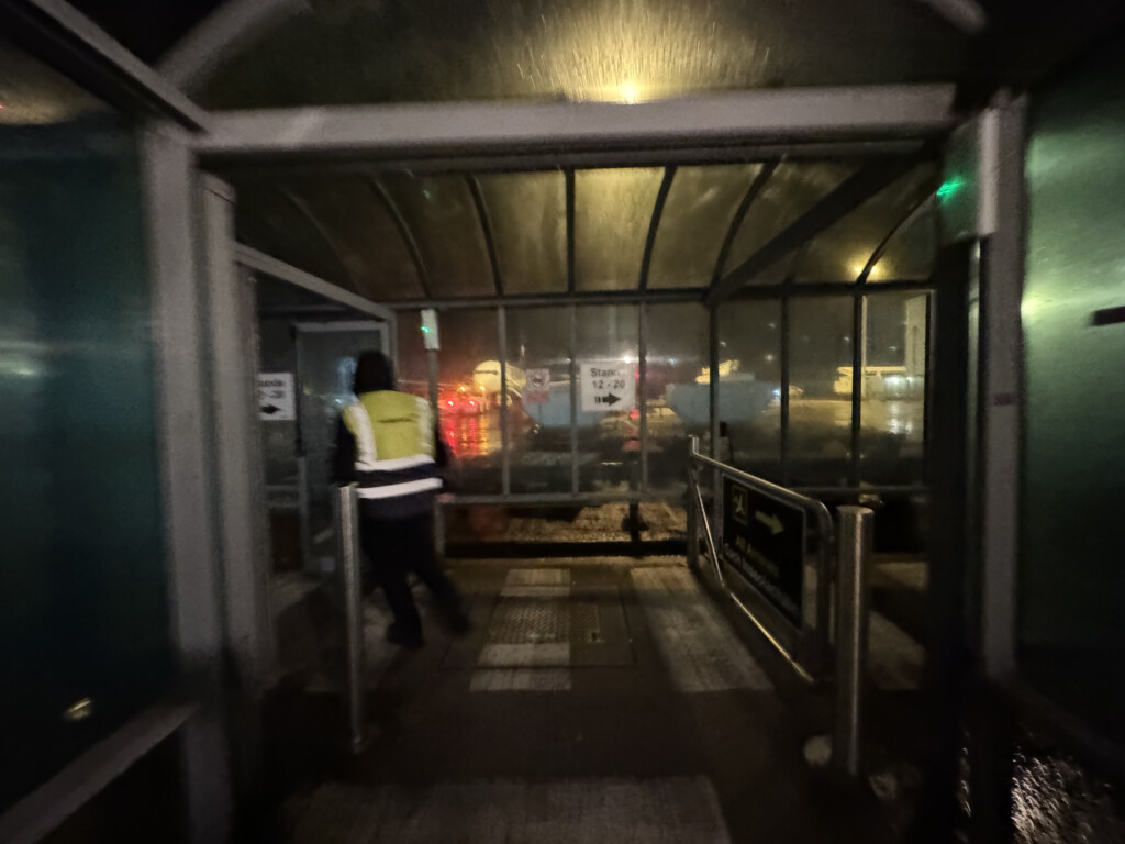 a person walking into a glass covered walkway