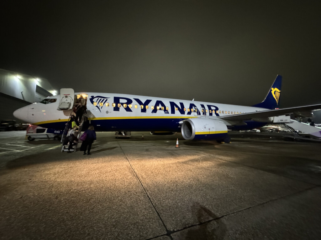 a plane with people boarding