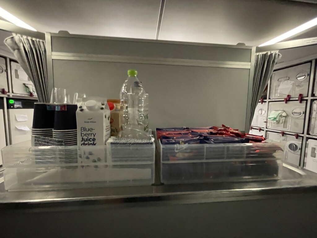 a counter with plastic containers and plastic cups