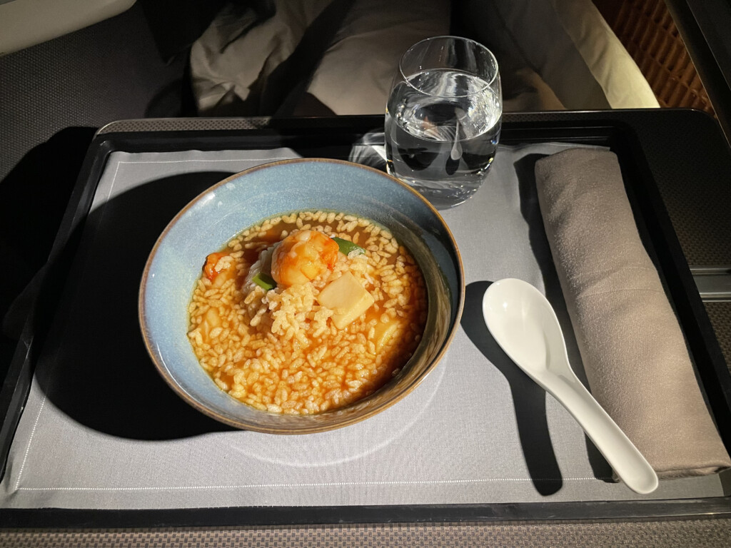 a bowl of rice and a spoon on a tray