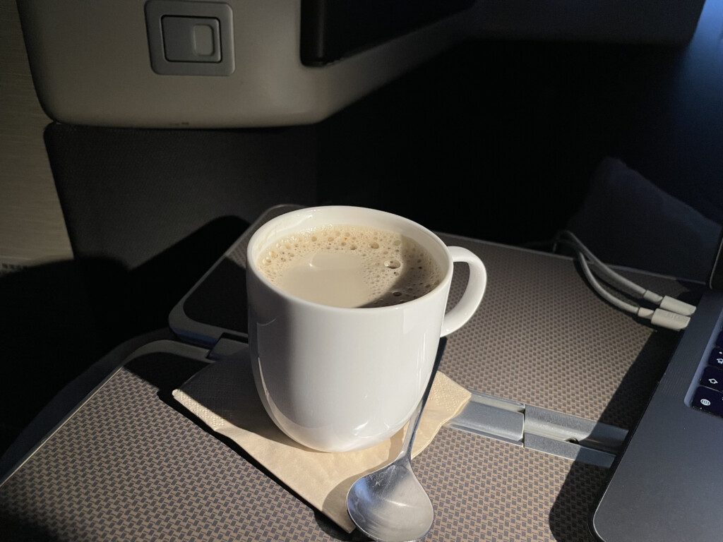 a cup of coffee on a napkin with a spoon