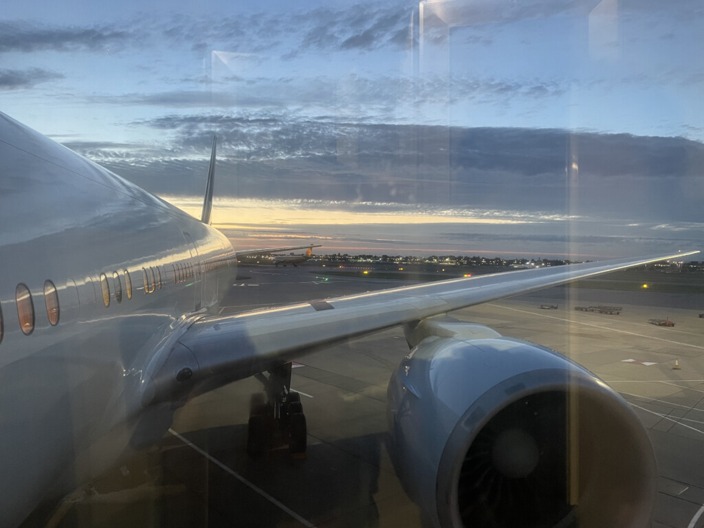 an airplane wing and engine on runway