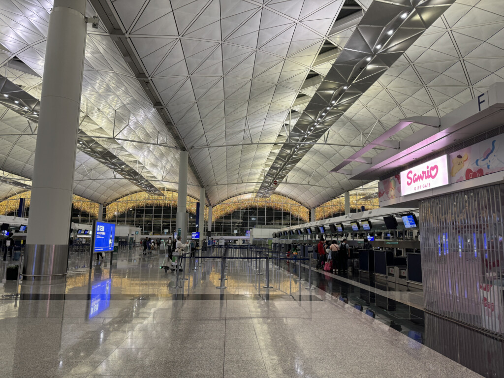 a large airport terminal with people walking around