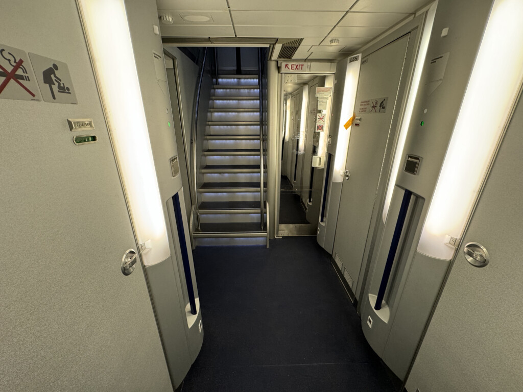 a hallway with stairs and doors