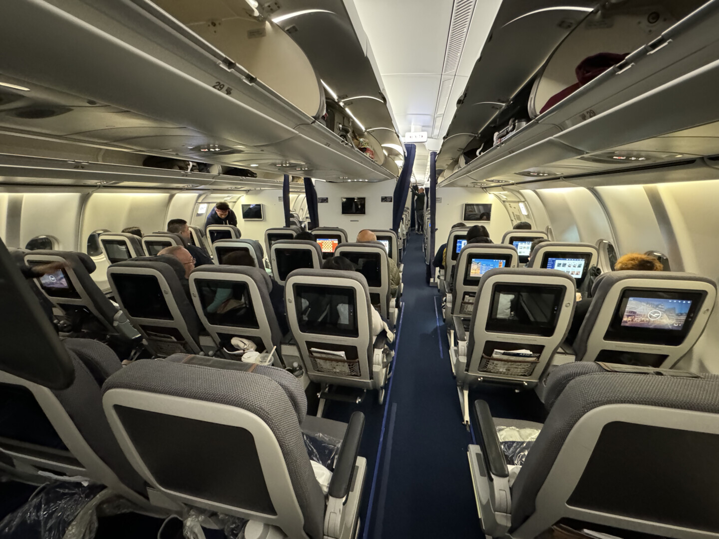 a group of people sitting in an airplane