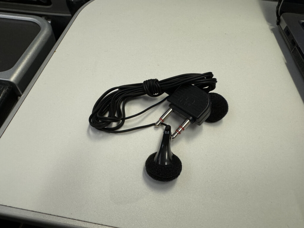 a black earbuds on a white surface