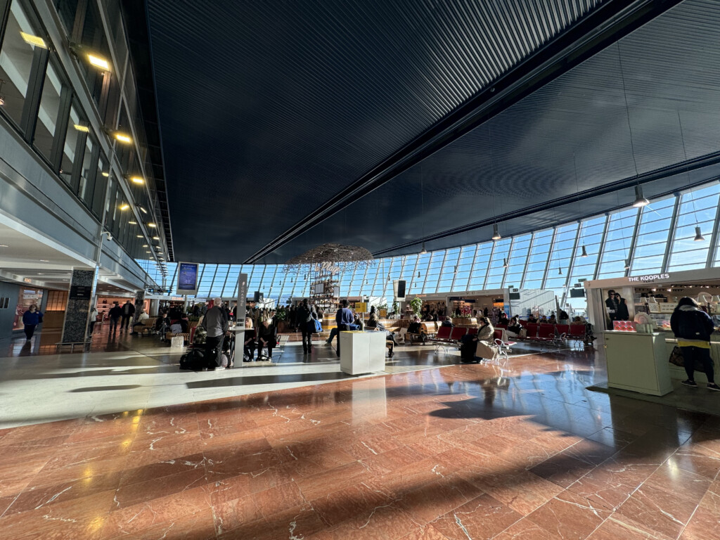 a large airport terminal with people walking around