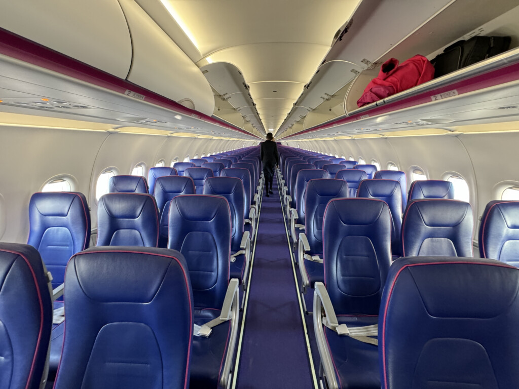 a row of blue seats on an airplane