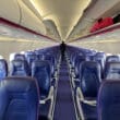 a row of blue seats on an airplane