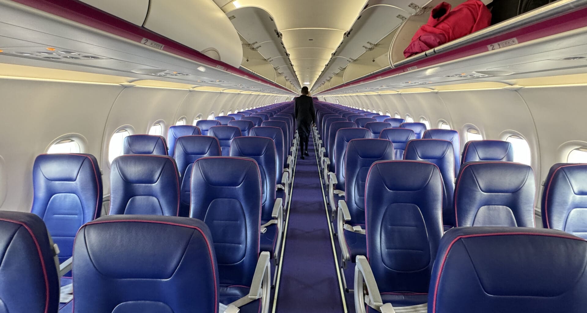 a row of blue seats on an airplane