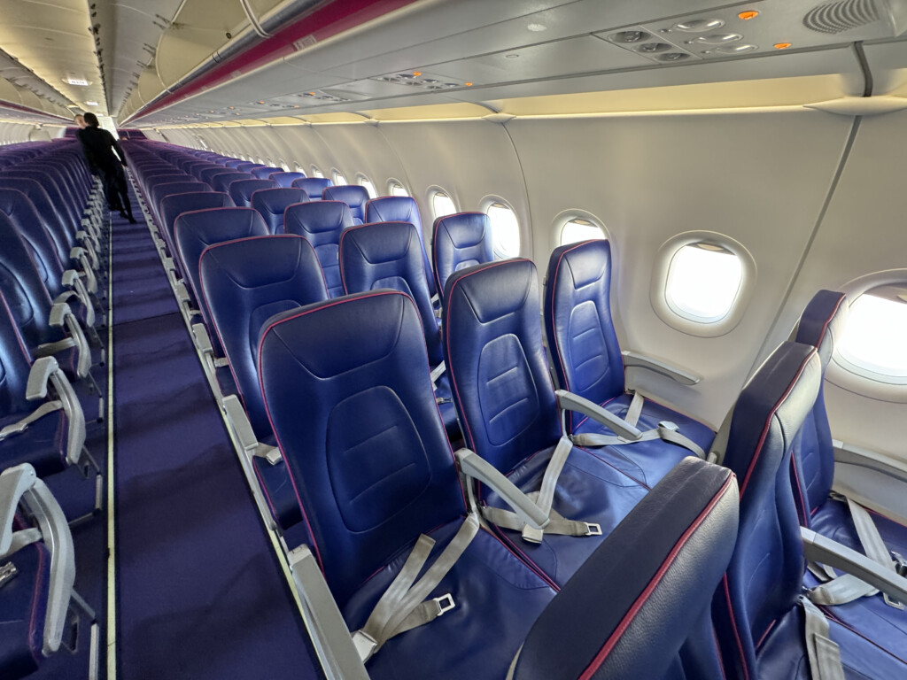 a row of blue seats on an airplane