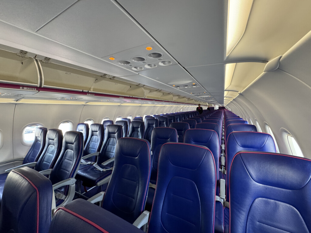 a row of blue seats in an airplane