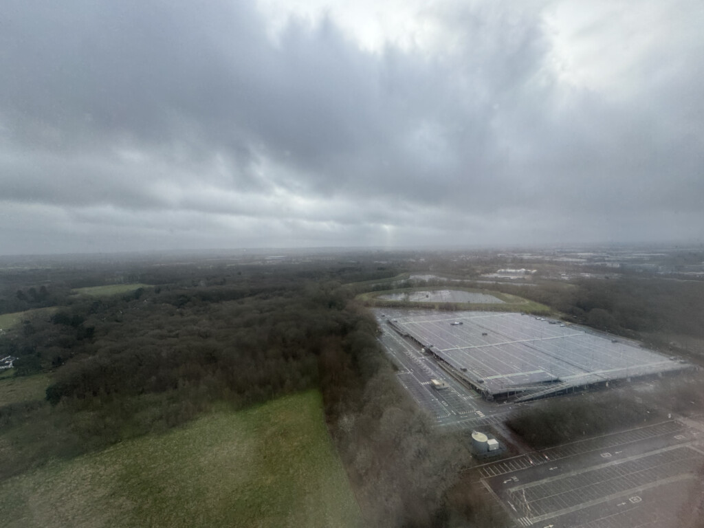 a aerial view of a parking lot and trees