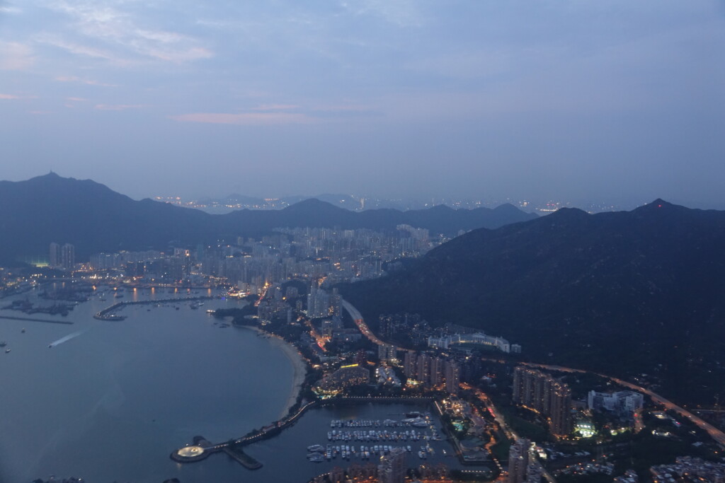 a cityscape with a body of water and mountains