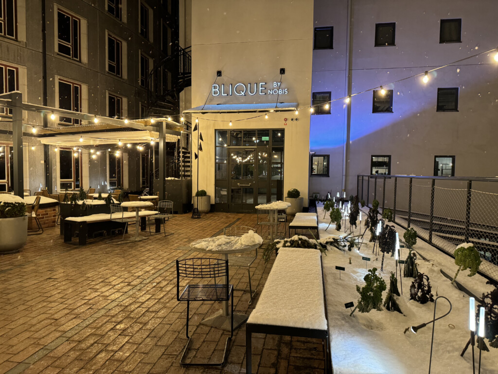 a building with lights and snow on the ground