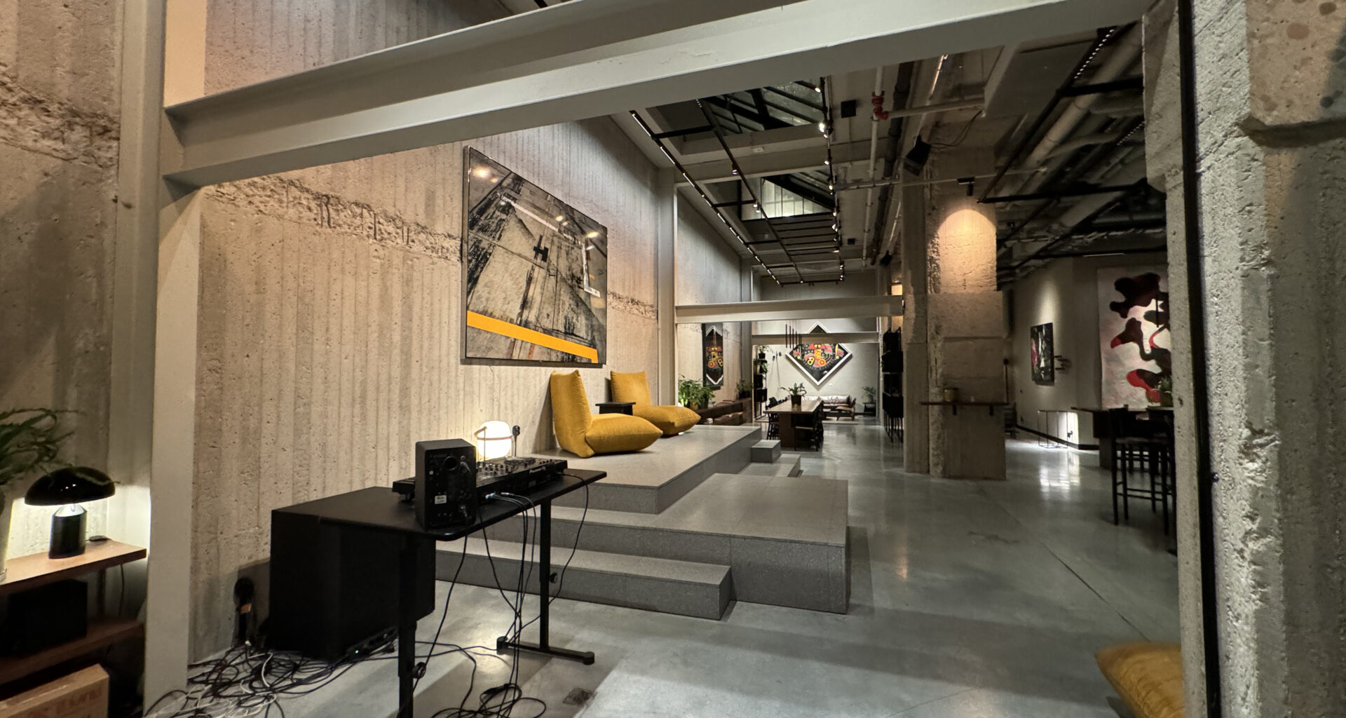 a room with a large white wall and a concrete floor