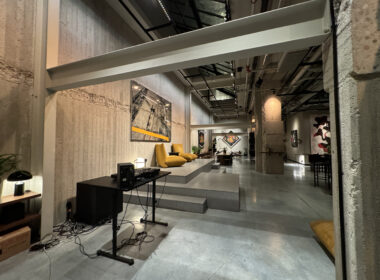 a room with a large white wall and a concrete floor