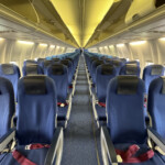 a row of blue seats on an airplane