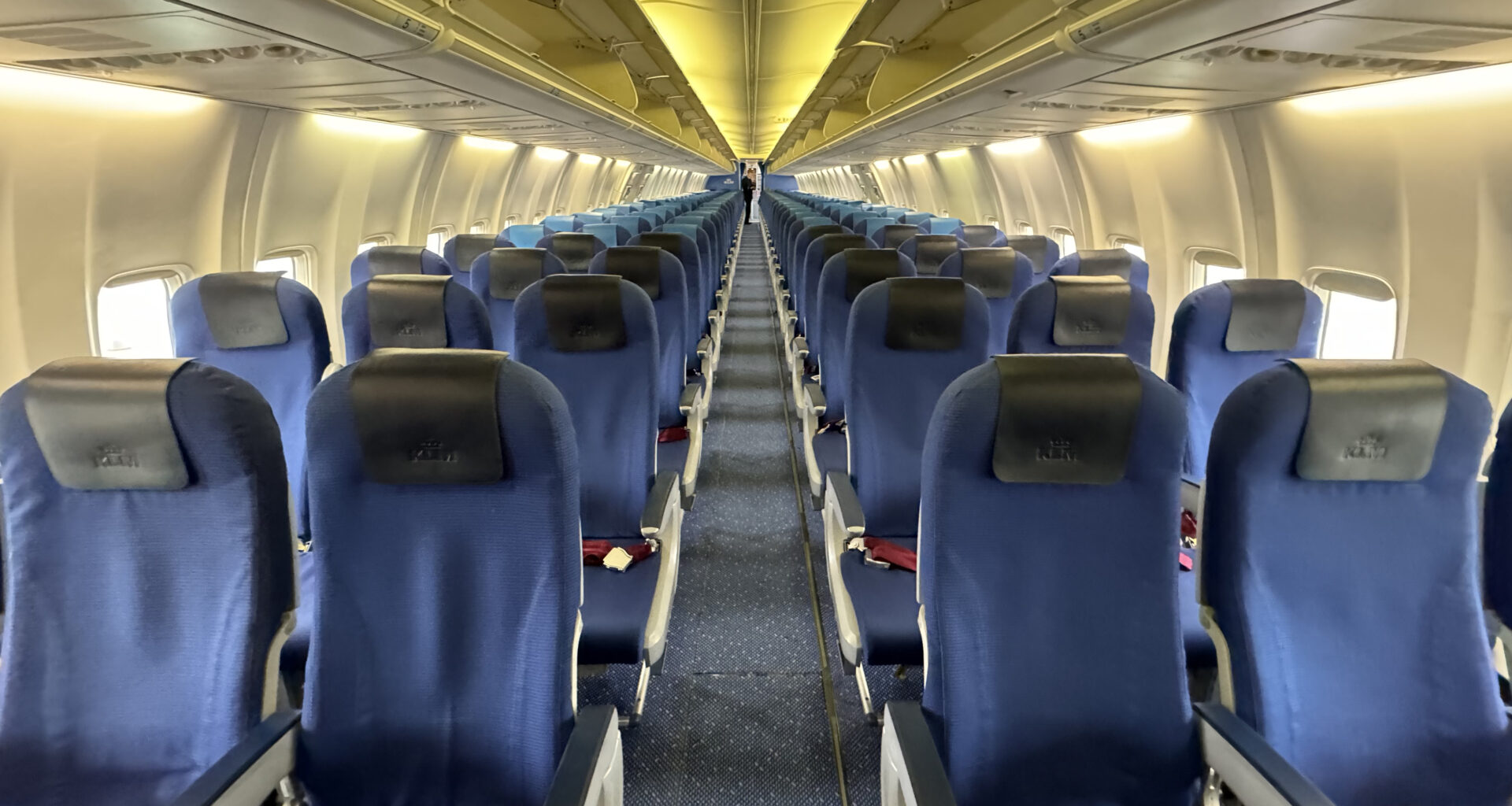 a row of blue seats on an airplane