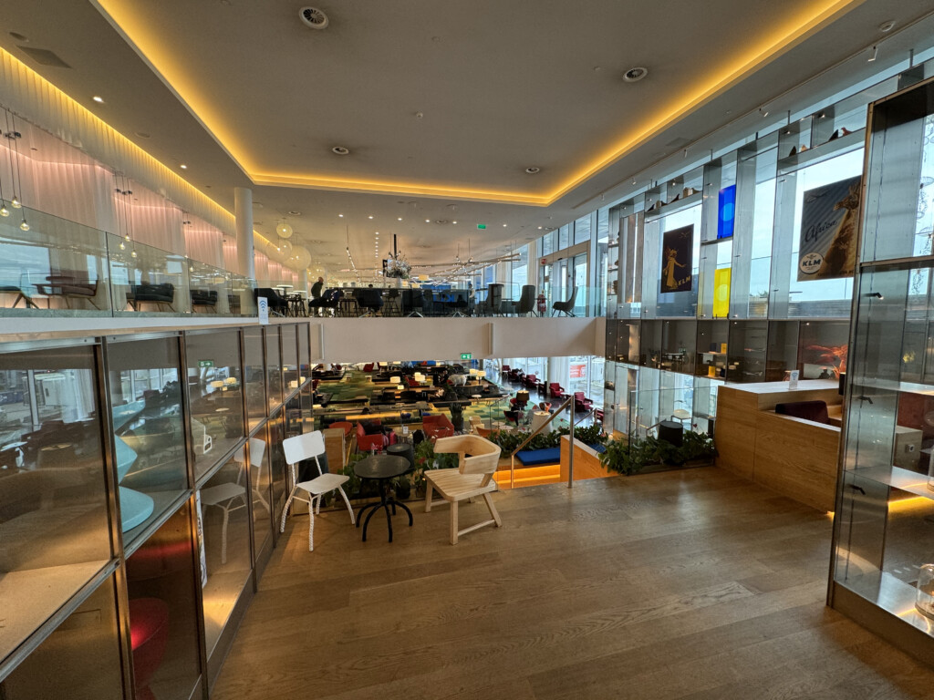 a room with glass walls and tables and chairs