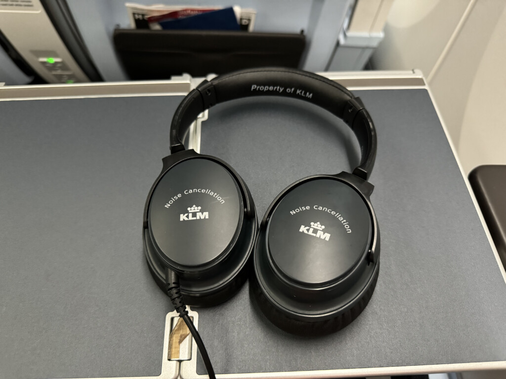 a pair of black headphones on a grey surface