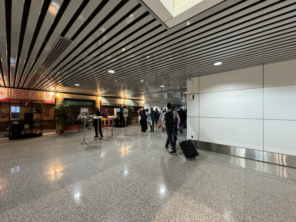 people in a building with a large white wall